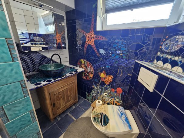 Maritimes Mosaik-Badezimmer von Caroline Jung mit blauen Fliesen und Seestern-Motiven